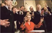  ?? Erika Schultz
Seattle Times ?? GOV. GREGOIRE signs Washington’s gay marriage law. Personal stories seem to be advancing the cause.