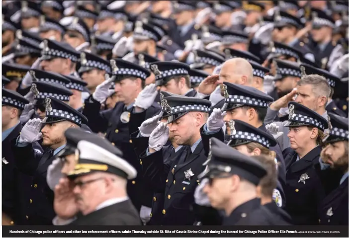  ?? ASHLEE REZIN/SUN-TIMES PHOTOS ?? Hundreds of Chicago police officers and other law enforcemen­t officers salute Thursday outside St. Rita of Cascia Shrine Chapel during the funeral for Chicago Police Officer Ella French.