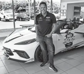  ?? PHOTOS BY TY WRIGHT/NEWARK ADVOCATE ?? The 2021 Indy 500 Corvette Pace Car is in the showcase room at Coughlin Chevrolet of Newark as Michael Shank, owner of Meyer-shank Racing in Pataskala, stands by the car as he was picking it up on Monday. Meyer-shank Racing Team built the car that won the Indianapol­is 500 this year. The racing team was allowed to pick the dealership that presented the car to them and Coughlin GM of Newark was picked.