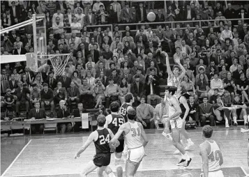  ?? JACK THORNELL / AP ?? LSU’s Pete Maravich (23) breaks the all-time scoring record on Jan. 31, 1970. Those who played with, followed or knew the late Maravich are conflicted about the seemingly inevitable moment — likely today — when he could be supplanted by Iowa women’s basketball sensation Caitlin Clark atop the NCAA’s all-time scoring list.