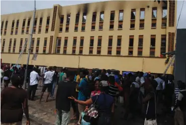  ??  ?? Students assess the extent of damage at Yaba College of Technology in Lagos after a fire outbreak. PHOTOS: Benedict Uwalaka