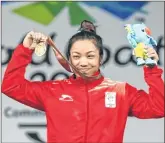  ??  ?? Mirabai Chanu celebrates with her medal at Gold Coast.