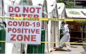  ?? AFP/VNA Photo ?? A man wearing personal protective equipment walking into a makeshift ward built for COVID-19 patients at a hospital in Manila.