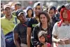  ?? GREGORY BULL/ASSOCIATED PRESS ?? Marvin Ochoa, center, waits in line for a meal behind his wife, Diana Marylin Ochoa, after they arrived in Tijuana, Mexico, with a Central America migrant caravan Thursday. The family had traveled from Honduras.