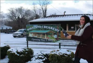  ?? COURTESY OF LAURA TEIGELER ?? Emily Christophe­r poses in front of the site of a new ice cream store coming in spring 2019. She will be operating the store.