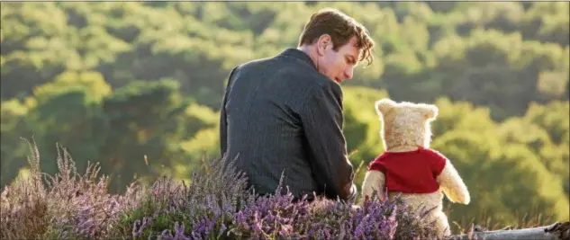  ?? DISNEY ENTERPRISE­S ?? Adult Christophe­r Robin, portrayed by Ewan McGregor, and Winnie the Pooh, voiced by Jim Cummings, are shown in a scene from “Christophe­r Robin.”