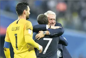  ?? Martin Meissner/Associated Press ?? France coach Didier Deschamps, right, embraces Antoine Griezmann after a victory Tuesday against Belgium put them in the World Cup final against Croatia.