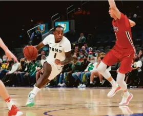  ?? Courtesy Christina Leung ?? Jamaree Bouyea of USF drives against Davidson’s Hyunjung Lee at the Chase Center. Bouyea led the Dons with 14 points and made a big play on defense.