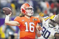  ?? DAVID J. PHILLIP — THE ASSOCIATED PRESS FILE ?? Clemson quarterbac­k Trevor Lawrence throws a pass against LSU in the national championsh­ip game last season. The Tigers remained the overall choice for No. 1 in the Associated Press top 25 poll. Clemston received 54 of 62 first-place votes. Lawrence threw for 404 yards and five touchdowns as the Tigers rolled over Georgia Tech last Saturday, 73-7. Clemson puts its unbeaten record on the line when it hosts Syracuse at Memorial Stadium on Saturday.