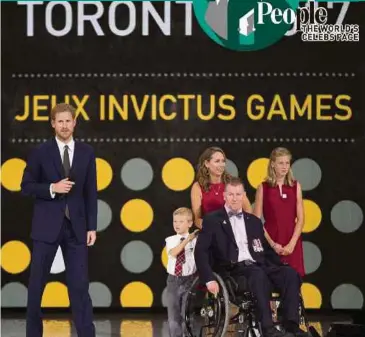  ?? AFP PIC ?? Prince Harry honours Captain (Rtd) Trevor Greene of the Canadian Armed Forces at the Invictus Games in Toronto, Ontario, on Saturday. He was nearly killed by an axewieldin­g assailant who struck him in the head in Afghanista­n.