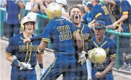  ?? JIM RASSOL/STAFF PHOTOGRAPH­ER ?? Gabe Terry (35) of St. Thomas Aquinas celebrates tying the game in the top of the seventh inning against teammate Nick Vera (10).