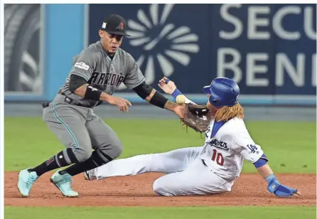  ?? JAYNE KAMIN-ONCEA/USA TODAY SPORTS ?? Diamondbac­ks shortstop Ketel Marte (left) misses a throw from catcher Jeff Mathis as Los Angeles Dodgers third baseman Justin Turner slides into second in the second inning of Friday’s game. Visit dbacks.azcentral.com for a recap of the late game.