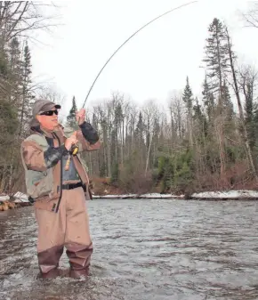  ?? PAUL A. SMITH ?? Dave Zeug of Shell Lake fights a steelhead on the Brule River in northern Wisconsin during a previous season.