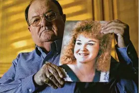  ?? Charlie Riedel / Associated Press ?? Mortuary owner Brian Simmons holds a photo of his daughter Rhonda Ketchum, 49. who died just before Christmas of COVID-19 in a Springfiel­d, Mo., hospital.