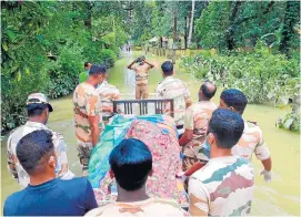  ??  ?? EN ALUVA, UNA PEQUEÑA CIUDAD del estado de Kerala (India), los vecinos y cuerpos de rescate han tenido que trabajar en unión para sacar de las casas a los enfermos en sus propias camas.