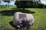  ?? NOREEN NASIR — THE ASSOCIATED PRESS ?? On July 10, a wreathe lies in front of a site commemorat­ing the 1919race riots in Chicago. The plaque is near the area where black teenager Eugene Williams was struck in the head with a rock and drowned in Lake Michigan, sparking race riots.