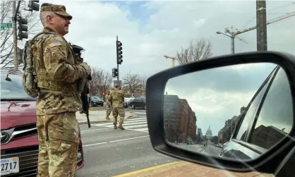 ?? Photograph: Jonathan Ernst/Reuters ?? US national guard soldiers staff a checkpoint a few blocks from the Capitol. Security measures have been dramatical­ly strengthen­ed.