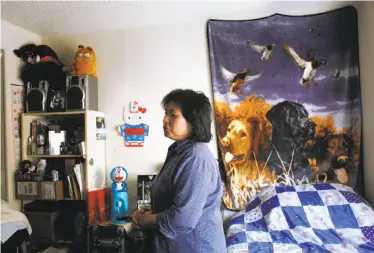  ?? Lea Suzuki / The Chronicle ?? Shut-Fan Lam, in her Oakland home, sometimes talks to daughter Cecilia with longing. “Daughter, you ... said you were coming home that weekend. Where are you? I’m still waiting . ... I wait for you every day.”