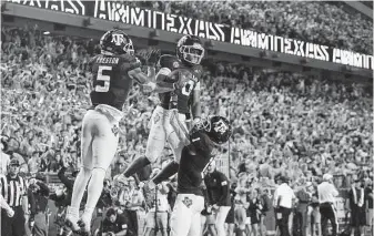  ?? Sam Craft / Associated Press ?? Texas A&M wide receiver Ainias Smith, center, celebrates with receivers Demond Demas, right, and Jalen Preston during the Aggies’ upset of No. 1 Alabama on Oct. 9 at Kyle Field.