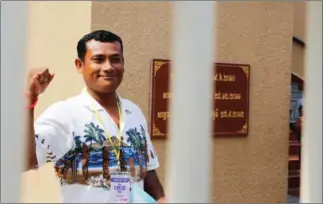  ?? PHA LINA ?? Land rights activist Chan Puthisak poses for a photograph outside Phnom Penh Court where he was questioned yesterday along with Licadho staffer Am Sam Ath.