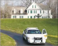  ?? Associated Press file photo ?? A police cruiser sits in the driveway of the home of Nancy Lanza in Newtown, the Colonial-style house where she had lived with her son Adam Lanza in 2012.
