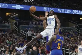  ?? JOHN RAOUX — THE ASSOCIATED PRESS ?? Orlando Magic center Bol Bol (10) shoots as he gets past Denver Nuggets guard Kentavious Caldwell-Pope (5) during the second half of an NBA basketball game on Thursday in Orlando, Fla.