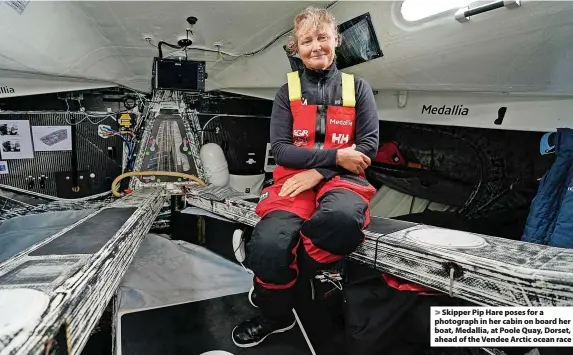  ?? ?? Skipper Pip Hare poses for a photograph in her cabin on board her boat, Medallia, at Poole Quay, Dorset, ahead of the Vendee Arctic ocean race