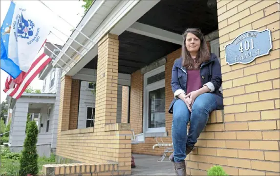  ?? Pam Panchak/Post-Gazette ?? Mary Chitwood, a former Army supply specialist, sits on the porch of Robin's Home in Butler, where she is creating a place for female veterans and their children who need transition­al housing. Robin’s Home will hold eight women and will be ready for occupancy in July.