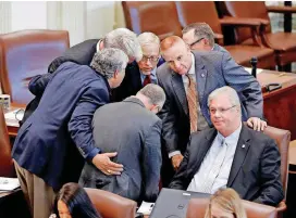  ?? [PHOTO BY JIM BECKEL, THE OKLAHOMAN ?? A group of Republican lawmakers huddle near the desk of state Rep. Mark Lepak, seated at right, during the recent special session of the Legislatur­e.