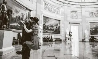  ?? Tasos Katopodis / Getty Images ?? Rep.-elect Troy Nehls of Texas hugs daughter Tori in the U.S. Capitol on Sunday. Both chambers are holding rare Sunday sessions to open the new Congress as the Constituti­on requires.