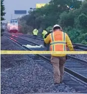  ?? JOE CAVARETTA/SOUTH FLORIDA SUN SENTINEL ?? Broward Sheriff ’s Office deputies and the Broward County Medical Examiner’s Office work the scene of a fatal 2020 TriRail train and pedestrian accident in Oakland Park.