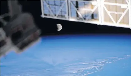  ?? NASA ?? The moon, pictured during a lunar eclipse on May 26, 2021, is seen from the Internatio­nal Space Station during a northwest to southeast orbital trek 263 miles above the Pacific Ocean. When the sun is close to a lunar node, and the full moon is near the node as well, a lunar eclipse occurs.