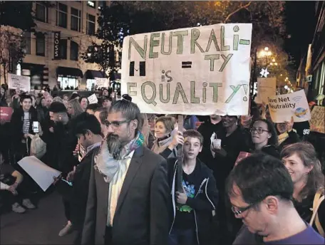  ?? Karl Mondon TNS ?? POLLS have shown strong public support for net neutrality. Above, backers of the online traffic rules rally in San Francisco in December.