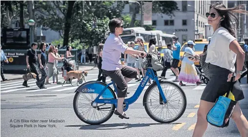  ??  ?? A Citi Bike rider near Madison Square Park in New York.