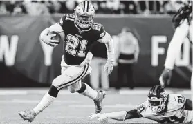  ?? Adam Hunger / Associated Press ?? Dallas Cowboys running back Ezekiel Elliott (21) would be happy with a third rushing title, but he has his sights set on the Super Bowl.
