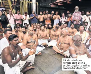  ??  ?? Hindu priests and temple staff sit in a protest against a ruling from India’s top court