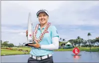  ?? AP PHOTO ?? Brooke Henderson of Canada holds the trophy after winning the LPGA Lotte Championsh­ip golf tournament Saturday in Kapolei, Hawaii.