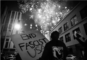  ?? AP Photo/Christian Monterrosa ?? Protesters light fireworks in the middle of downtown Oakland during a protest on Saturday in Oakland, Calif.