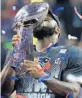  ?? MIKE EHRMANN/GETTY IMAGES ?? James White gives a kiss to the Vince Lombardi Trophy after the game.