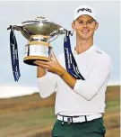  ??  ?? In the clear: Brandon Stone shows off his trophy after a course-record 60