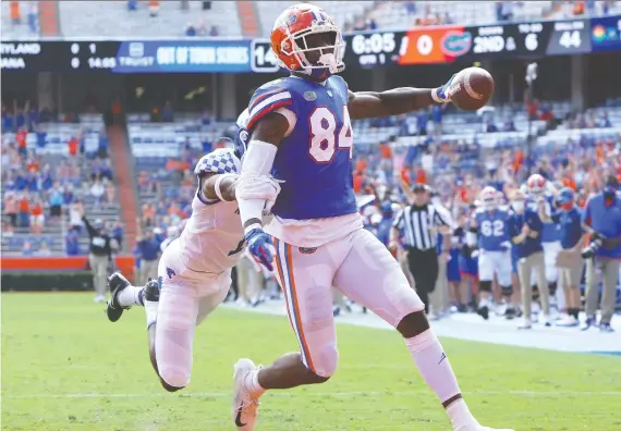  ?? BRAD MCLENNY/THE ASSOCIATED PRESS FILES ?? At six foot six and 245 pounds, fleet-footed Florida Gators tight end Kyle Pitts — seen scoring against Kentucky last season — is a matchup nightmare. He's too big for a cornerback and too fast for a linebacker. His 12 touchdowns set a record for a Florida tight end and he's a lock to go in the top 10 in this year's NFL draft.