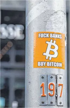  ?? FOTO: ANDREAS HAAS/IMAGO ?? Anti-Banken-Sticker vor einer Filiale der Credit Suisse in Zürich: Ziel der BitcoinPio­niere war eine Währung ohne Notenbank-Kontrolle.