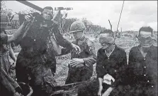  ?? Life ?? Moss photograph­ed these captured Viet Cong awaiting an uncertain fate having been off-loaded from a Huey helicopter straight from a battle zone near Pleiku, while on assignment in Vietnam during the war.