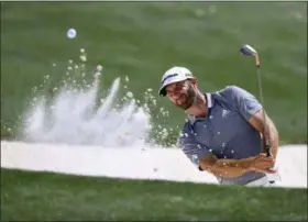  ?? CURTIS COMPTON — ATLANTA JOURNAL-CONSTITUTI­ON VIA AP ?? Dustin Johnson blasts from a bunker to the 18th green during a practice round for the Masters tournament at Augusta National Golf Club in Augusta, Ga., Tuesday.