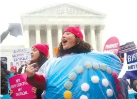  ?? AP PHOTO/CHARLES DHARAPAK ?? Margot Riphagen of New Orleans, wears a birth control pill costume in 2014 as she protests in front of the Supreme Court in Washington.