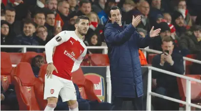  ?? (John Sibley/Reuters) ?? ARSENAL MANAGER Unai Emery gives instructio­ns to Sead Kolasinac as he prepares to come on during the Europa League match vs Sporting CP earlier this month at the Emirates.