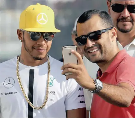  ?? REUTERS ?? ALWAYS GOT TIME FOR AN INSTAGRAM: Lewis Hamilton poses for a photograph with a fan yesterday. The Formula One champion arrived late for practice ahead of tomorrow’s Brazil Grand Prix.