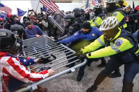  ?? The Associated Press ?? Trump supporters try to break through a police barrier, Wednesday, at the Capitol in Washington. As Congress prepared to affirm Presidente­lect Joe Biden’s victory, thousands gathered to show their support for President Donald Trump and his baseless claims of election fraud.