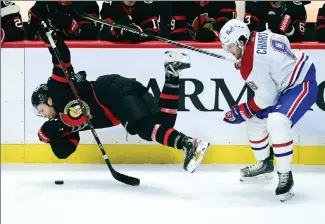  ?? Canadian Press photo ?? Ottawa Senators right wing Connor Brown gets hit to the ice by Montreal Canadiens defenceman Ben Chiarot during third period NHL action in Ottawa on Tuesday.