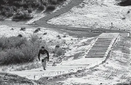  ?? Kevin Mohatt, Special to The Denver Post ?? Jimmy Waidler jogs up the newly developed Rueter- Hess Incline Challenge in Parker on Thursday.